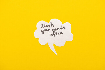 top view of speech bubbles with wash your hands lettering on yellow background