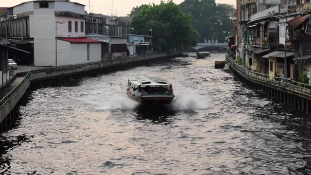 Water Bus Boat Traveling through Narrow Canals in Bangkok, Thailand