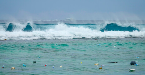 Fototapeta premium Big barrel wave crashing toward the coast brings more litter to exotic island.