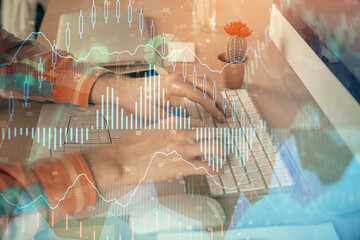 Double exposure of stock market chart with man working on computer on background. Concept of financial analysis.