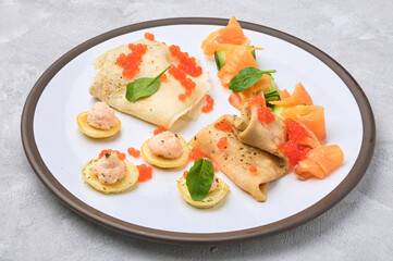 Russian pancakes with salmon and red caviar