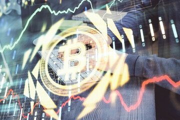 Crypto currency theme hologram with businessman working on computer on background. Concept of blockchain. Multi exposure.