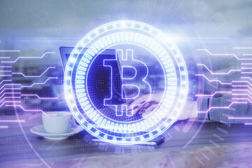 Crypto currency theme hologram with businessman working on computer on background. Concept of blockchain. Double exposure.