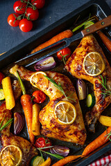 Grilled chicken legs with various vegetables and herbs.