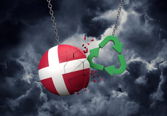 Obraz premium Green recycle symbol crashing into a Denmark flag ball. 3D Rendering