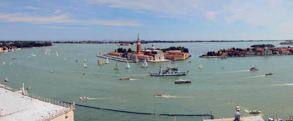Panoramic aerial view of Venetian Lagoon with San Giorgio Maggiore Island and Regatta from St. Mark's Campanile. Venice. Italy.