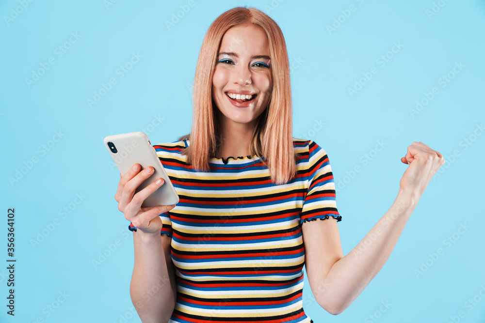 Sticker image of excited girl using cellphone and making winner gesture