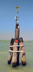 Old wooden Beacon in Venetian Lagoon. Venice. Italy.