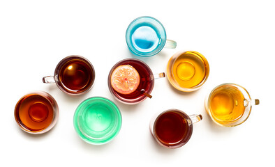 Various colorful herbal tea collection in glass cups on white background