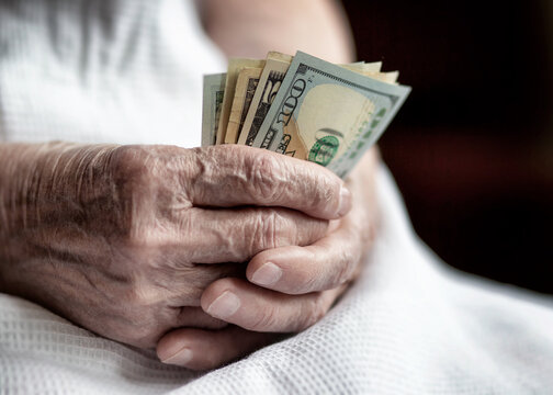 Dollar Bills In The Hands Of An Old Woman Close-up. Elderly Woman With Money In Hand.