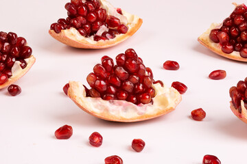 Ripe peeled pomegranate. Pieces of pomegranate on a white background.