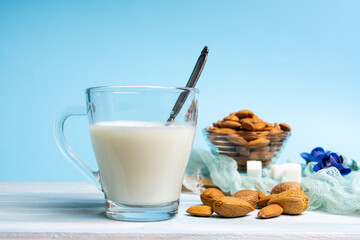 Almond Milk in a Glass on blue background