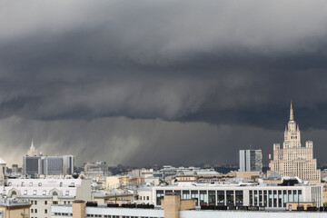 urban cityscape panorama day view of buildings, monuments, roofs, rooftops on a dark stormy sky and...