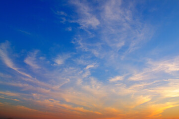 Naklejka na ściany i meble Beautiful sunset. Blue sky and golden clouds.
