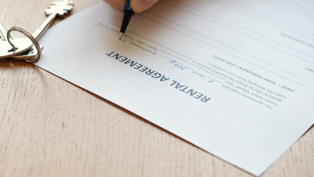 Woman filling a rental agreement form, lease contract. Close up