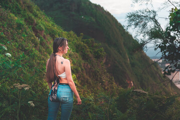 Young white girl with white shirt and jeans in the mountain.
