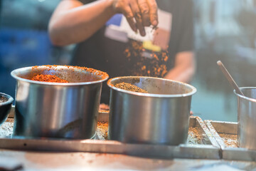Chinese chef adding spices to food