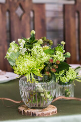 
A delightful composition in green colors with a glass vase on the banquet table to create a romantic atmosphere.