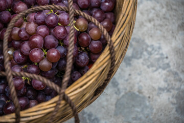 Shot of fresh grapes in a basket on the ground