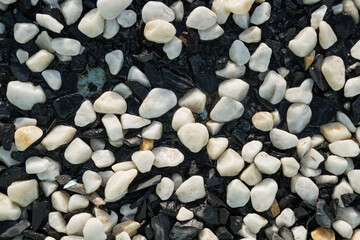 Background image of small black and white round pebbles