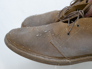water drops on waterproof suede desert boots shoes after use weatherproof spray, apparel care...
