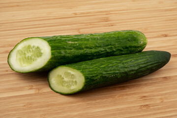 Green cucumber on a wooden background