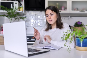 Woman teacher, mentor, psychologist looking at webcam of laptop