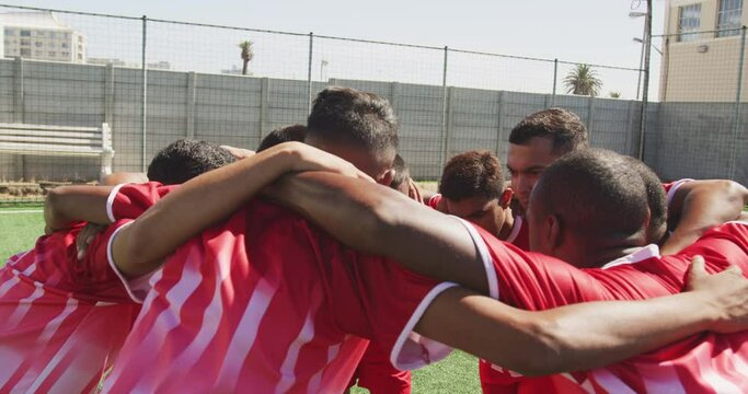 Soccer players motivating on field