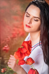 Fototapeta premium Young woman on the beautiful poppy field