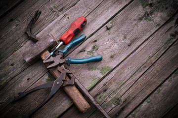Various hand tools isolated on a wooden background, close-up. Industrial tools, space for text,...