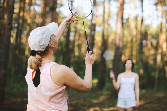Two women plaining in bambinton in forest