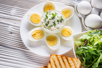 boiled chicken eggs on a white wooden rustic background