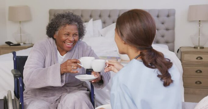 Mixed race woman being visited at home by a nurse. Social distancing and self isolation in quarantin
