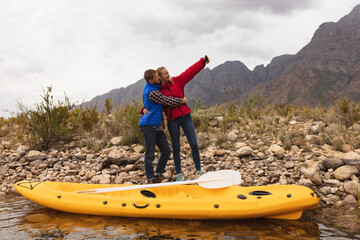 Caucasian couple took a selfie near their kayak