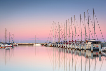 Fototapeta na wymiar Beautiful sunset over the marina at Baltic Sea with yachts in Gdynia, Poland.