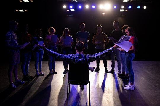 Rear view of teacher in front of students in a theater