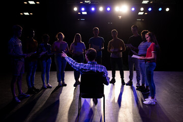 Rear view of teacher in front of students in a theater
