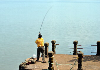 man fishing on the pier