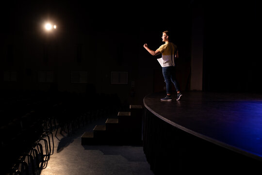 Side view of student practicing in a theater
