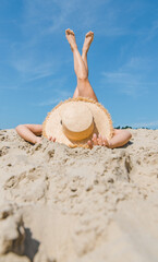 Fototapeta na wymiar woman laying at sand beach crossing legs up vacation