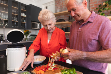 Caucasian senior couple cooking together at home