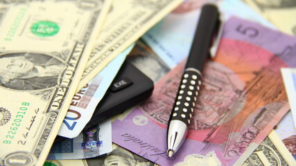 Pencil, calculator and paper money. Business. Economy. Finance.