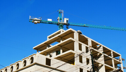 Tower crane and building activity. Construction site background.