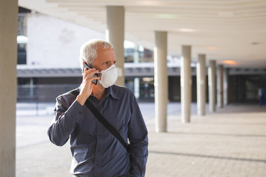 Middle Aged Man Wearing Coronavirus Covid 19 Mask On The Go 