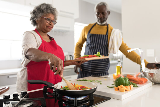 A senior African American couple spending time together at home and cooking