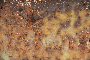 Rusty, orange surface of weathered iron plate, machine.