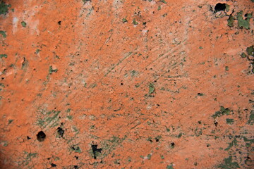 Rusty, orange surface of weathered iron plate, machine.