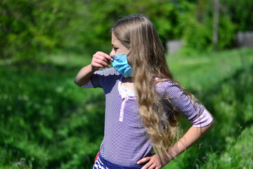 Fototapeta premium Protection from the flu. Allergy. A little girl in a mask during the pandemic virus.