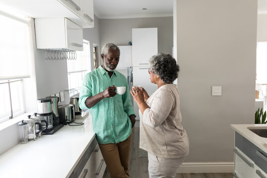 An African American couple spending time together at home and enjoying a beverage