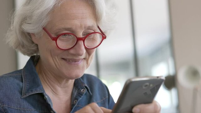 Portrait of senior woman using smartphone